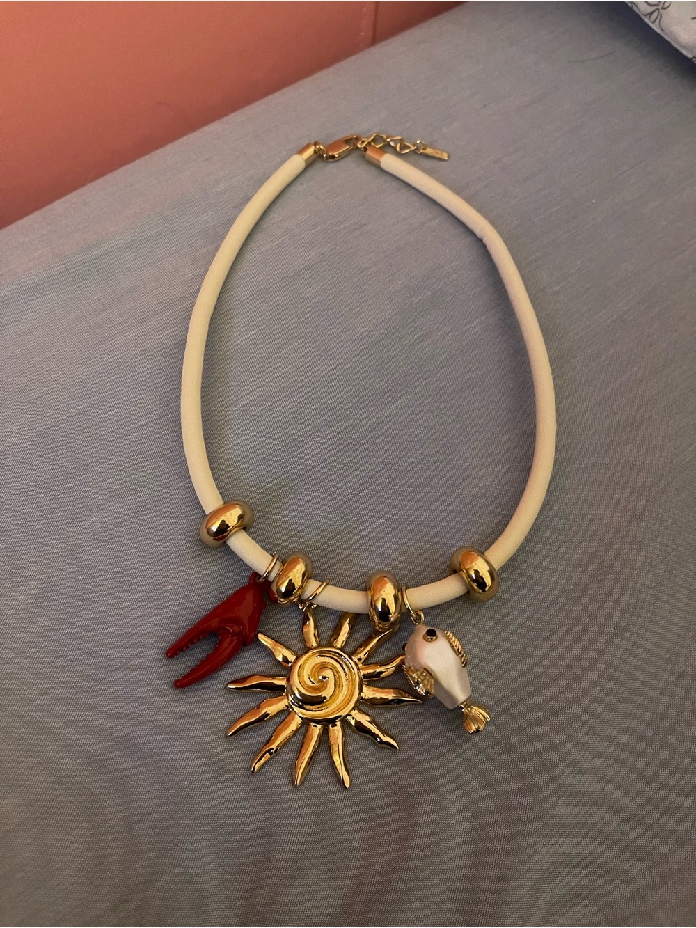 Zara Gold Sun Charm Necklace with Cream Cord and Red & White Accents
